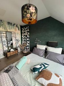 a bedroom with a giraffe bed with a mirror at CHAMBRE DANS UN ECRIN DE VERDURE in Angrie