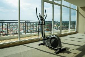 an exercise bike in a room with a large window at Family Holiday Fun APT Netflix by MESA in Nagoya