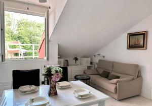 a living room with a couch and a table at El Solsticio - 30601 in Somo