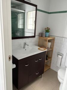 a bathroom with a sink and a mirror and a toilet at Villa Paula Trinidad in Salou +18 photos