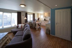 a living room with a couch and a dining room at Am Treis in Wieringerwerf