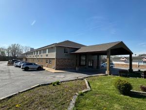 a building with cars parked in a parking lot at The Sage Hotel in Muscatine