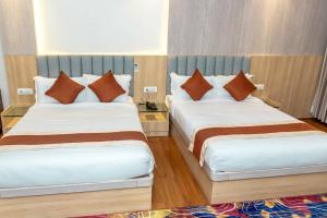 Ένα ή περισσότερα κρεβάτια σε δωμάτιο στο Hotel Badrinath