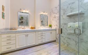 a bathroom with two sinks and a shower at Palacio Blanco Luxury Villa 2 in La Ventana