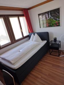 Postel nebo postele na pokoji v ubytování Hotel Alpha Thun