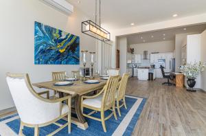 a dining room and living room with a table and chairs at Palacio Blanco Luxury Villa 2 in La Ventana