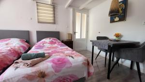 a bedroom with a bed and a desk and a table at BnB Souterrain in Amsterdam