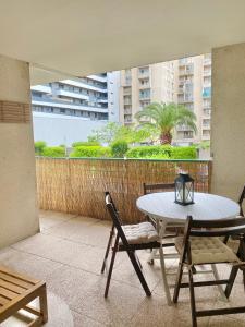 a patio with a table and chairs on a balcony at La PASSERELLE in Toulouse
