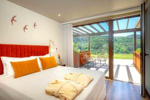 a bedroom with a large bed with birds on the wall at Quinta de Cabanas Douro Country House in Penha Longa +76 photos