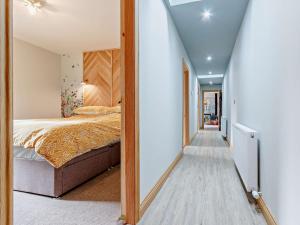 a hallway leading to a bedroom with a bed at 3 Bed in Lanark 81079 in Forth