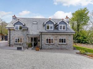 a large stone house with a gravel driveway at 5 Bed in Falmouth 65745 in Gwennap