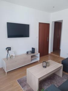 a living room with a tv and a coffee table at Natura House in Aveiro