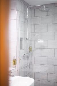 a bathroom with a shower and a sink at Trevose Golf and Country Club in Padstow