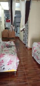 a bedroom with two beds and a wooden floor at Casa mobilhada para alugar durante o FIG 2024 in Garanhuns