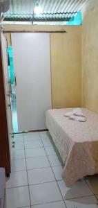 a bedroom with a bed in a room with a door at Casa mobilhada para alugar durante o FIG 2024 in Garanhuns