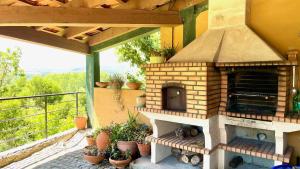a patio with an outdoor oven on a balcony at Villa Amarela in Penafiel