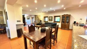 a kitchen and living room with a table and a couch at Villa Amarela in Penafiel