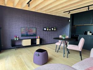 a room with a table and two chairs and a kitchen at Durbuy Insolite - Natural Escape in Durbuy