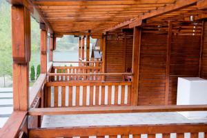 an outside view of a wooden building with a porch at Etno selo Bok in Vrhpolje