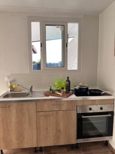 a kitchen with a sink and a counter top at A MO TI KOTE in Guenouillet