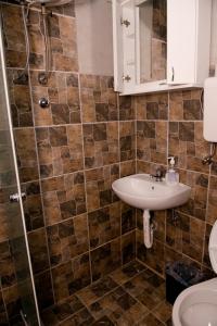 a bathroom with a sink and a shower at Etno selo Bok in Vrhpolje