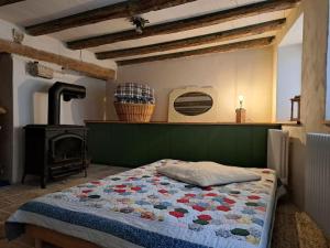 a bedroom with a bed with a stove in it at Romantisches Dinkelsbühler Altstadthäuschen inklusive Badewanne in Dinkelsbühl