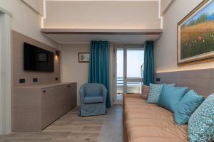 a living room with a couch and a chair at Hotel Porto Roca in Monterosso al Mare