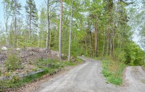 a dirt road in the middle of a forest at Lovely Home In Kallinge in Kallinge