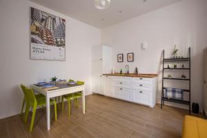 a kitchen with a table and some chairs and a counter at -Art Gallery- Luxury Boutique in center of Como in Como +32 photos