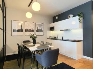 a kitchen and dining room with a table and chairs at Old Town Residence Gdansk in Gdańsk