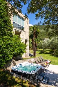 a house with a hot tub in the yard at Lake House La Gemma in Riva del Garda