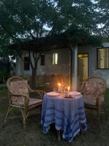 a table with two chairs and two candles on it at Velipoja Sea House in Velipojë