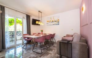 a living room with a table and chairs and a couch at Cozy Home In Starigrad Paklenica in Starigrad-Paklenica