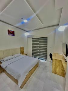 - une chambre avec un lit, un bureau et une télévision dans l'établissement رويال جروب اربد Royal Group Hotel, à Irbid