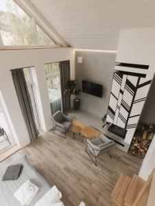 a living room with two chairs and a table at Apart-hotel Vershina in Yaremche