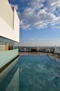 a swimming pool on the roof of a building at Novotel Lubumbashi in Lubumbashi