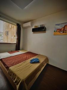 a small room with two beds and a window at Varna Cathedral Apartments in Varna City