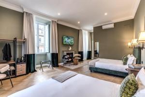 a hotel room with two beds and a fireplace at Dimore Paganica in Rome