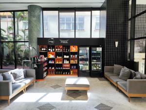 a room with two couches and a shelf of drinks at BOOK A FLAT Jardins São Paulo in São Paulo