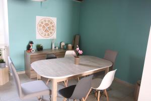 a dining room with a wooden table and chairs at Agréable maison de ville de 120m² à Villejust in Villejust +17 photos