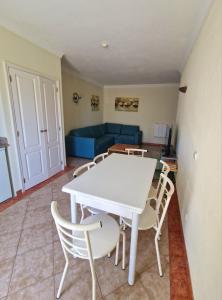 - un salon avec une table et des chaises blanches dans l'établissement Praia Oura Sunset, à Albufeira