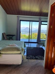 a bedroom with a bed and a view of the ocean at Vistaverde Lodge in Monteverde Costa Rica