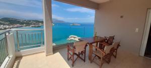 a dining room with a view of the ocean at Villa Dina Apartments in Almirida