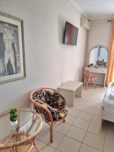 a living room with a chair and a table at Hotel Nautilos in Sozopoli