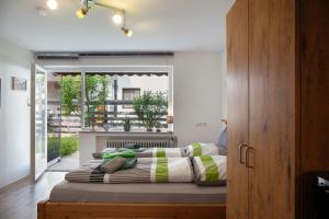 a bed in a room with a large window at Apartment Biendl in Mittenwald