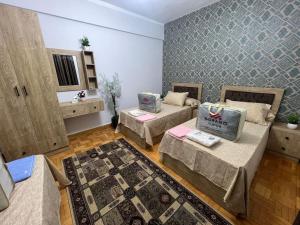 a living room with two beds and a rug at A luxury apartment fully nile view -Downtown Cairo in Cairo
