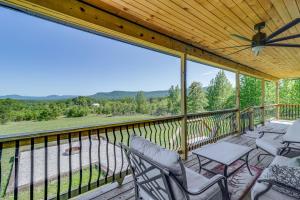 porche cubierto con sillas y ventilador de techo en Arkansas Retreat with Deck, Fire Pit and Mtn Views!, en Jasper