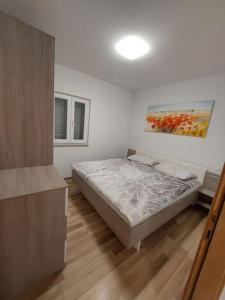 a bedroom with a bed and a painting on the wall at Spacious 3 Bedroom Apartment 50m from Sea 2 Bathrooms 2 Terraces Near Beach in Privlaka