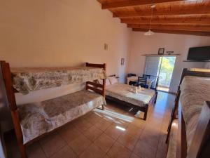 a bedroom with two bunk beds and a couch at Los Abuelos Apart in General Pico