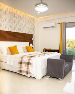 a bedroom with a large bed and a chair at Hotel el barco in Azua de Compostela